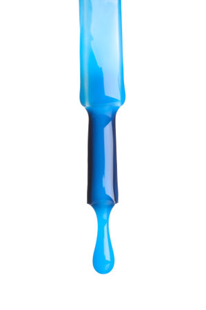 Blue nail polish dripping from brush isolated on whiteの写真素材