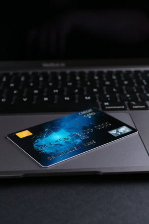 Laptop with credit card on grey table, closeupの写真素材