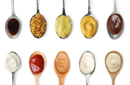 Set of different sauces in spoons isolated on white, top viewの写真素材