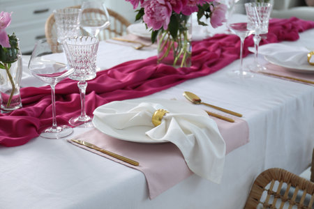 Beautiful table setting with pink color accentの写真素材