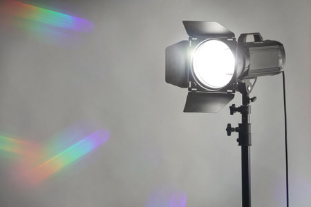 Gray photo background and professional lighting equipment in studio. Space for text