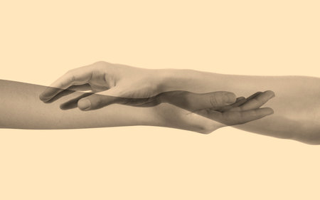 Double exposure of people's hands on beige background, closeup. Sepia effectの写真素材