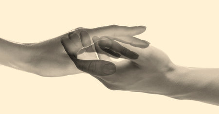 Double exposure of people's hands on beige background, closeup. Sepia effectの写真素材