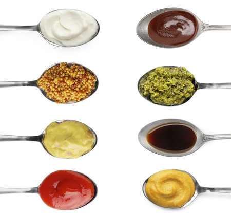 Set of different sauces in spoons isolated on white, top viewの写真素材