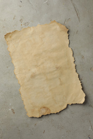Sheet of old parchment paper on grey table, top viewの写真素材