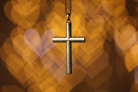 Wooden cross against blurred lights, closeup. Religion of Christianity