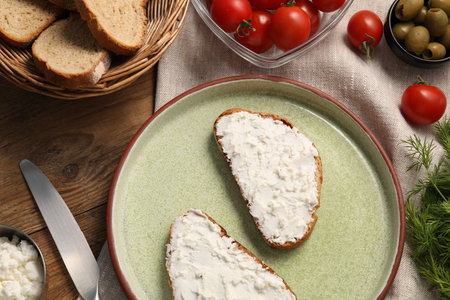 Delicious ricotta bruschettas and products on wooden table, flat layの写真素材