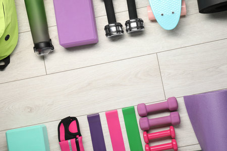 Frame of different sports equipment on white wooden table, flat lay. Space for textの写真素材