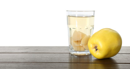 Delicious quince drink and fresh fruit on wooden table against white backgroundの写真素材