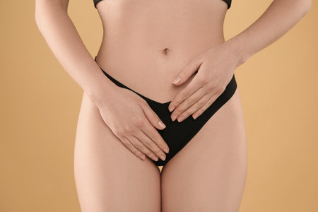 Gynecology. Woman in underwear on yellow background, closeupの写真素材