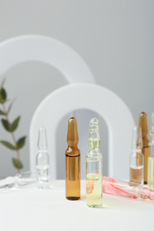 Stylish presentation of different skincare ampoules on white backgroundの写真素材