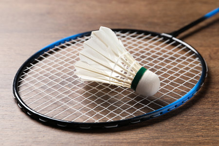 Feather badminton shuttlecock and racket on wooden table, closeupの写真素材