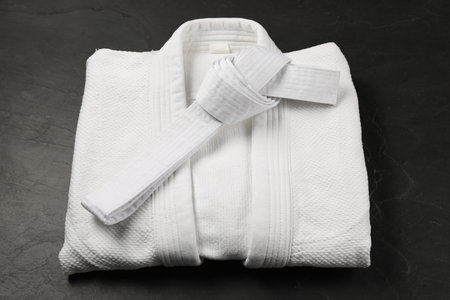 White karate belt and kimono on gray backgroundの写真素材