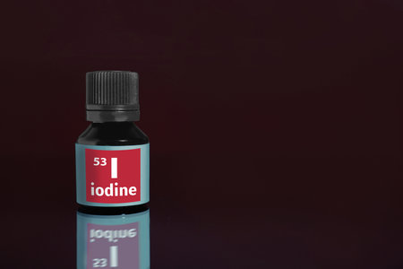 Bottle of medical iodine on dark background. Space for text