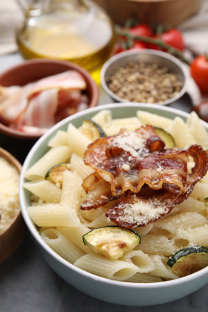 Tasty pasta with bacon and cheese on gray table, closeupの写真素材