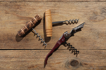 Different corkscrews on wooden table, flat layの写真素材