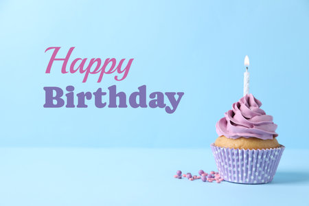 Birthday cupcake with candle on light blue background. Greeting cardの写真素材