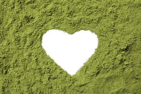 Heart-shaped frame made of green matcha powder on white background, top viewの写真素材