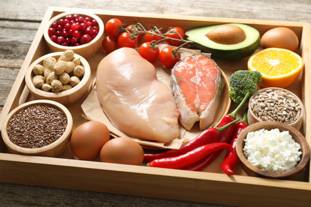 Tray with many different healthy foods on wooden table, closeupの写真素材