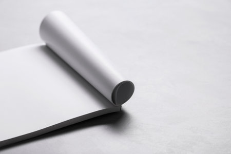 Blank paper sheets on gray textured table. Mockup for design