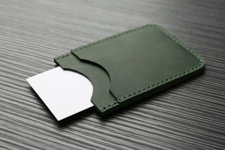 Leather business card holder with card on gray table, closeupの写真素材