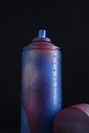 One spray paint can with cap on dark backgroundの写真素材