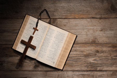 Bible and crosses on wooden table, top view with space for text. Religion of Christianity
