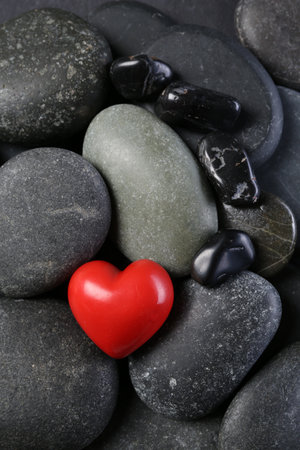 Red decorative heart on pebble stones, top viewの写真素材