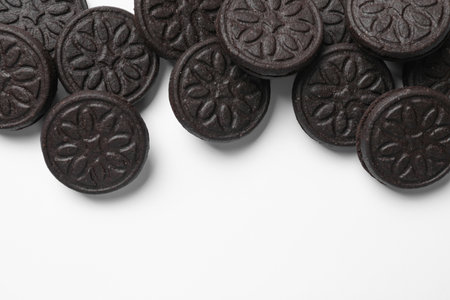 Tasty sweet sandwich cookies on white background, flat lay. Space for text