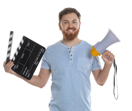 Making movie. Happy man with clapperboard and megaphone on white backgroundの写真素材