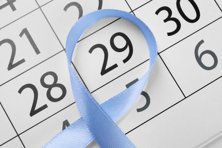 International Psoriasis Day. Light blue ribbon and calendar page with marked date, top viewの写真素材