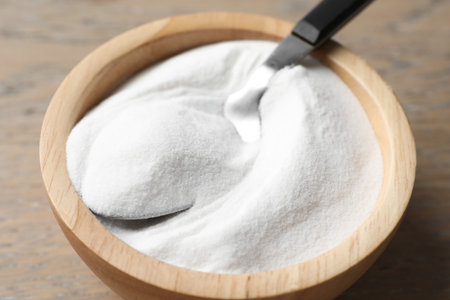 Baking soda in bowl on wooden table, closeupの写真素材