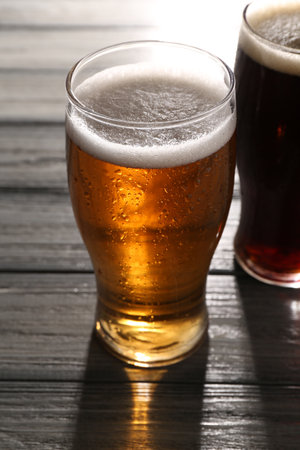 Glasses with different types of beer on gray wooden table, closeupの写真素材