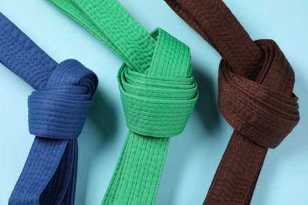 Colorful karate belts on light blue background, flat layの写真素材
