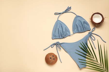 Flat lay composition with beautiful swimsuit on beige background. Space for textの写真素材