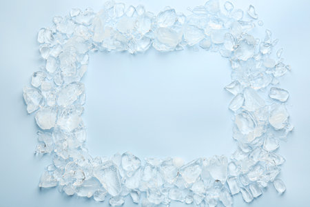 Frame of crushed ice on light blue background, top view. Space for textの写真素材