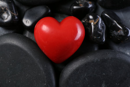 Red decorative heart on pebble stones, above viewの写真素材