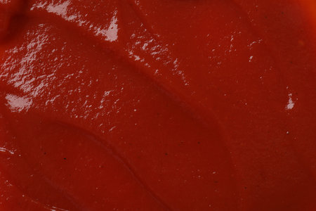 Texture of tasty ketchup as background, top view. Tomato sauceの写真素材