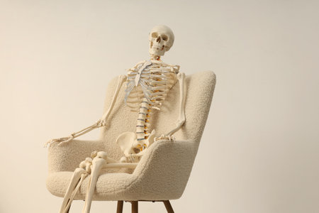 Waiting concept. Human skeleton sitting in armchair indoors, space for textの写真素材