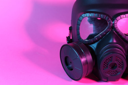 One gas mask on pink background, closeup. Space for textの写真素材