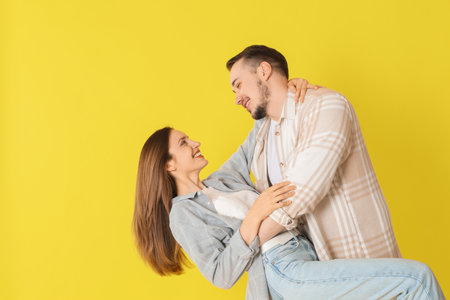 Happy couple dancing on yellow background. Space for textの写真素材