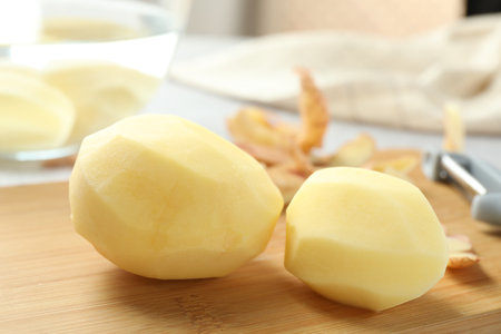 Peeled fresh raw potatoes on table, closeupの写真素材