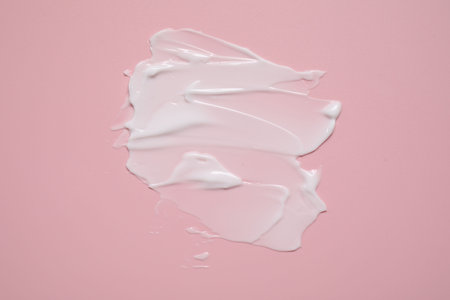 Face cream on pink background, top viewの写真素材