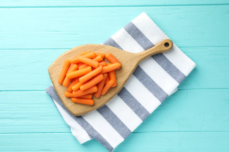 Baby carrots on light blue wooden table, top viewの写真素材