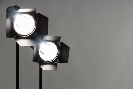 Grey photo background and professional lighting equipment in studio. Space for textの写真素材