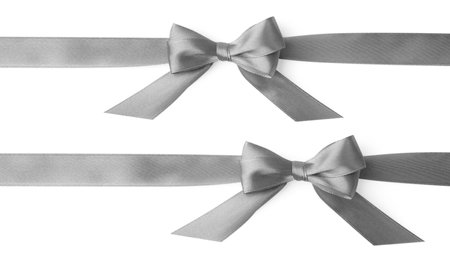 Beautiful silver satin bows isolated on whiteの写真素材