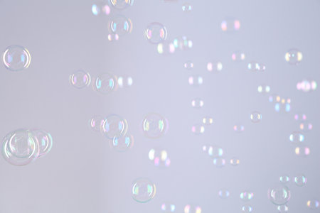 Beautiful transparent soap bubbles on gray backgroundの写真素材