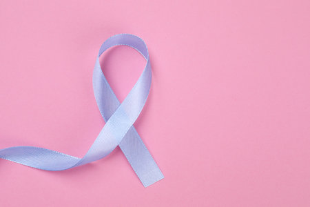 International Psoriasis Day. Ribbon as symbol of support on pink background, top view. Space for textの写真素材