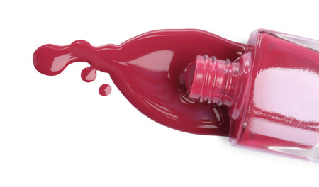 Bottle and spilled pink nail polish isolated on white, top viewの写真素材