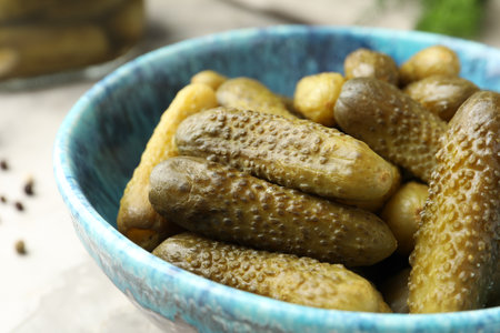 Pickled cucumbers in bowl on gray table, closeupの写真素材